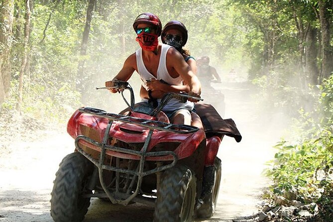 ATV Cenote and Zipline Adventure from Tulum - Riding the ATV over jungle roots and rocks